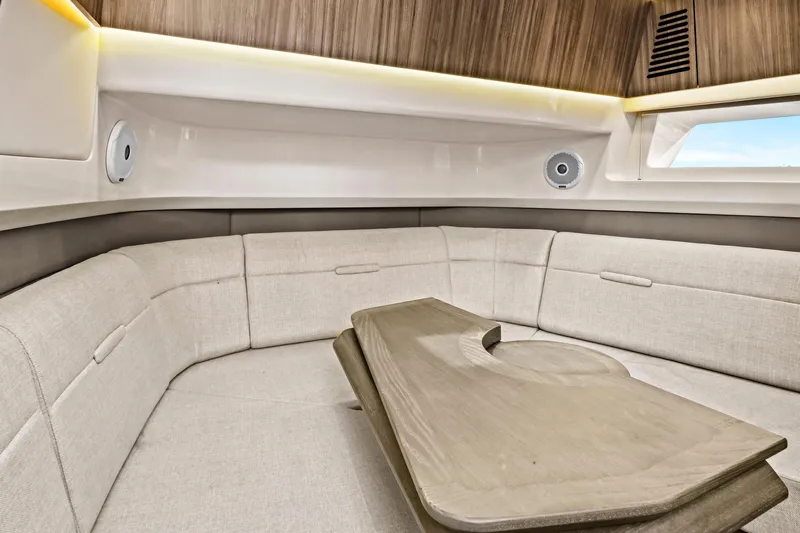 Sensei I Yacht Photos Pics Luxurious interior of 2021 Sea Ray SLX 400 boat with elegant seating and wooden table.