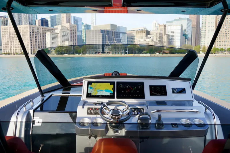  Yacht Photos Pics 2025 Pardo Yachts 43 helm with city skyline view, featuring modern navigation equipment.