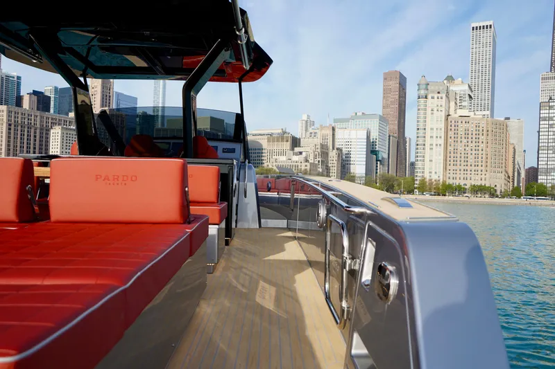  Yacht Photos Pics 2025 Pardo Yachts 43 with red seating, city skyline in background, docked by the water.