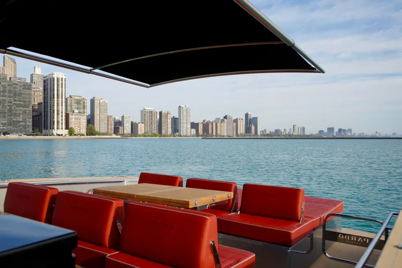  Yacht Photos Pics Luxurious 2025 Pardo Yachts 43 with red seating, city skyline view, and calm waters.