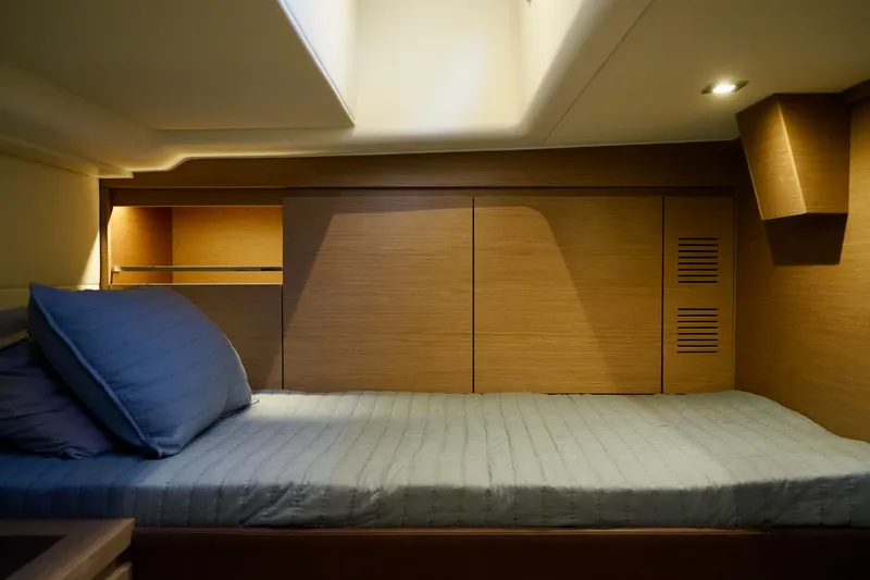  Yacht Photos Pics 2025 Pardo Yachts 43 interior cabin with wooden finish and cozy bedding.