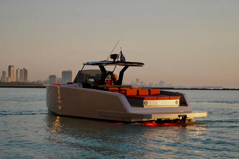  Yacht Photos Pics 2025 Pardo Yachts 43 cruising at sunset with city skyline in background.