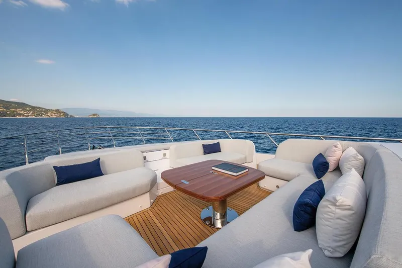 Dejavu Yacht Photos Pics Luxurious Azimut 78 yacht deck with elegant seating, ocean view, and wooden table, 2020 model.
