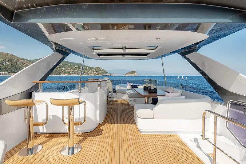 Dejavu Yacht Photos Pics Luxurious 2020 Azimut 78 yacht interior with elegant seating, bar stools, and ocean view.
