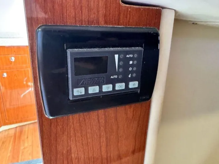 Out With The Buoys II Yacht Photos Pics Control panel on 2009 Regal Commodore 4060 yacht interior with wood finish.