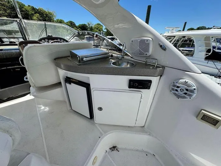 Out With The Buoys II Yacht Photos Pics 2009 Regal Commodore 4060 yacht interior with kitchenette, sink, and seating area.
