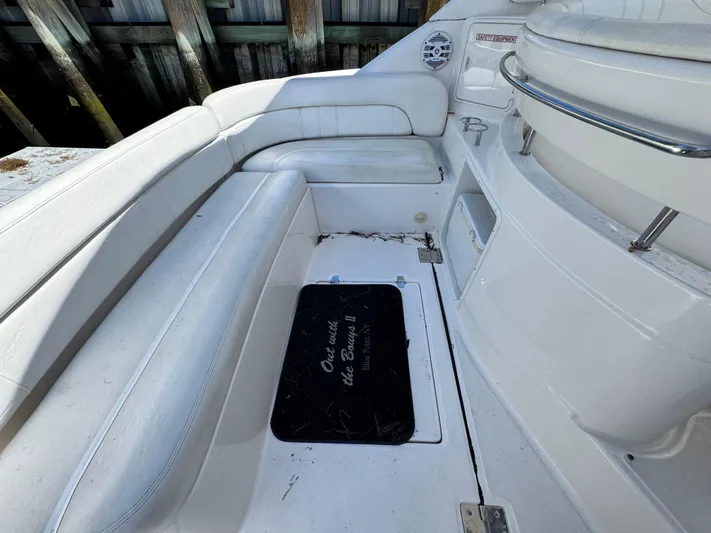 Out With The Buoys II Yacht Photos Pics 2009 Regal Commodore 4060 boat interior with white seating and storage hatch.