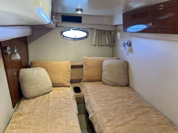 Out With The Buoys II Yacht Photos Pics Interior cabin of 2009 Regal Commodore 4060 with twin beds and porthole window.