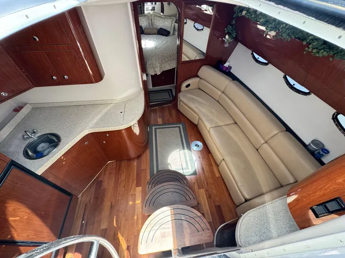 Out With The Buoys II Yacht Photos Pics Interior of 2009 Regal Commodore 4060 yacht with wood flooring and beige seating.