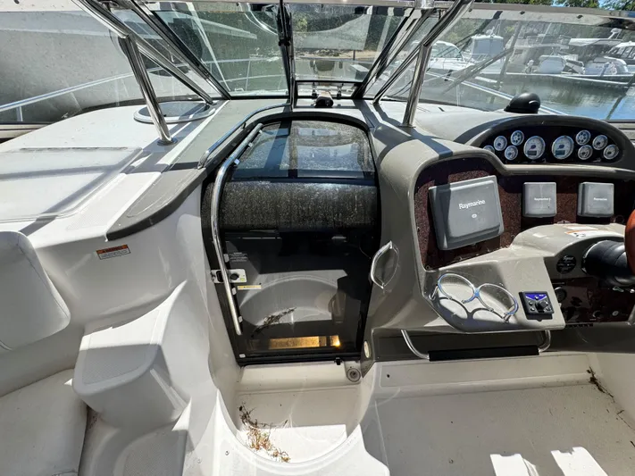 Out With The Buoys II Yacht Photos Pics Cockpit of 2009 Regal Commodore 4060 yacht with steering controls and navigation equipment.