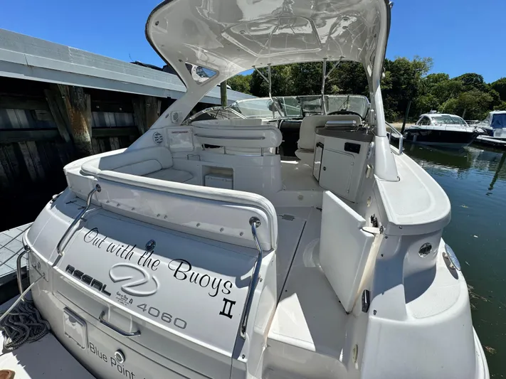 Out With The Buoys II Yacht Photos Pics 2009 Regal Commodore 4060 yacht docked, featuring spacious deck and seating area.