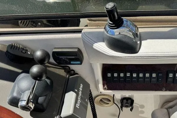 Out With The Buoys II Yacht Photos Pics Control panel of a 2009 Regal Commodore 4060 boat with joystick and switches.