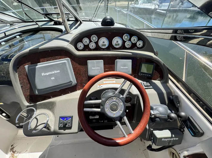 Out With The Buoys II Yacht Photos Pics 2009 Regal Commodore 4060 helm with Raymarine electronics and wood-accented steering wheel.