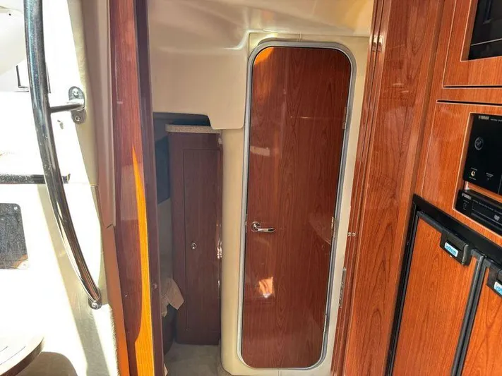 Out With The Buoys II Yacht Photos Pics Interior of 2009 Regal Commodore 4060 yacht with wooden cabinetry and door.