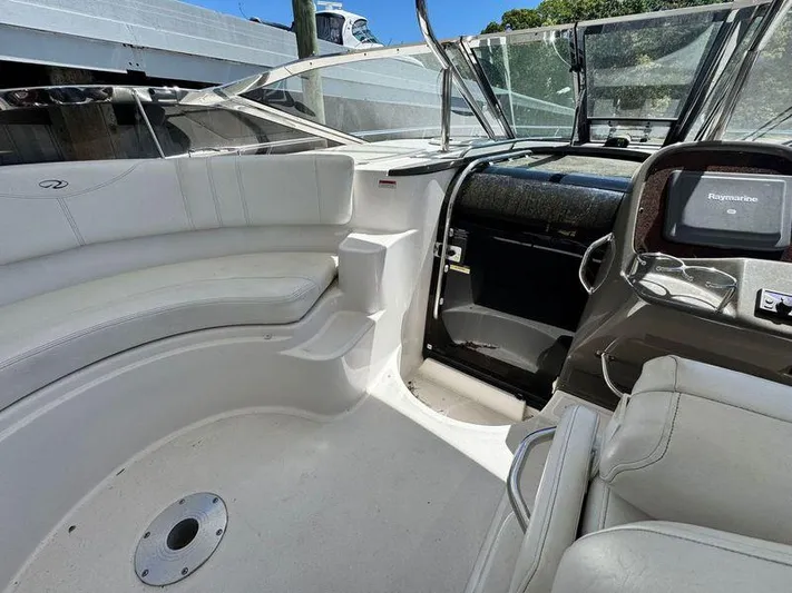 Out With The Buoys II Yacht Photos Pics 2009 Regal Commodore 4060 boat interior with white seating and navigation equipment.