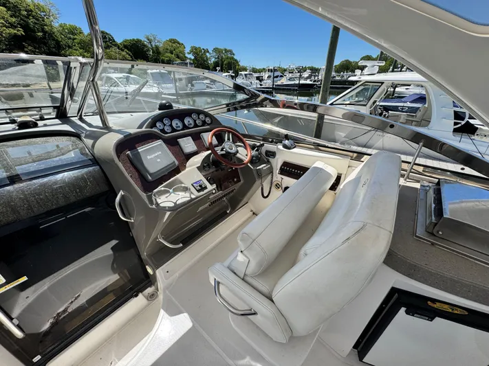 Out With The Buoys II Yacht Photos Pics 2009 Regal Commodore 4060 yacht cockpit with steering wheel and control panel.