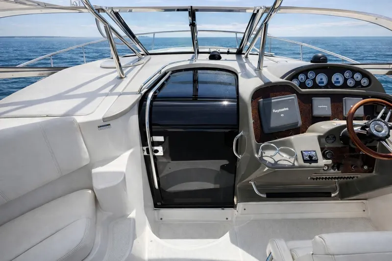 Out With The Buoys II Yacht Photos Pics 2009 Regal Commodore 4060 yacht cockpit with steering wheel and navigation controls.