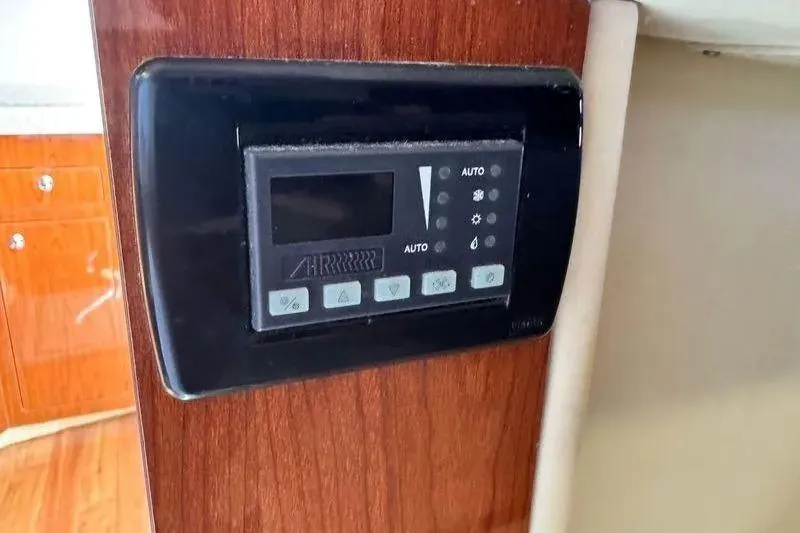 Out With The Buoys II Yacht Photos Pics Control panel on 2009 Regal Commodore 4060 yacht, mounted on wooden interior.