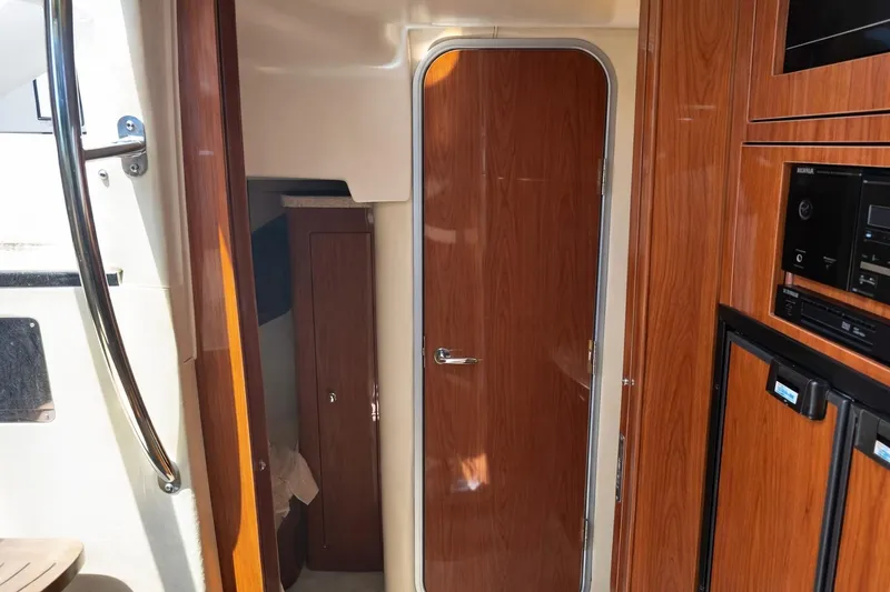 Out With The Buoys II Yacht Photos Pics Interior of 2009 Regal Commodore 4060 yacht with wooden cabinetry and door.