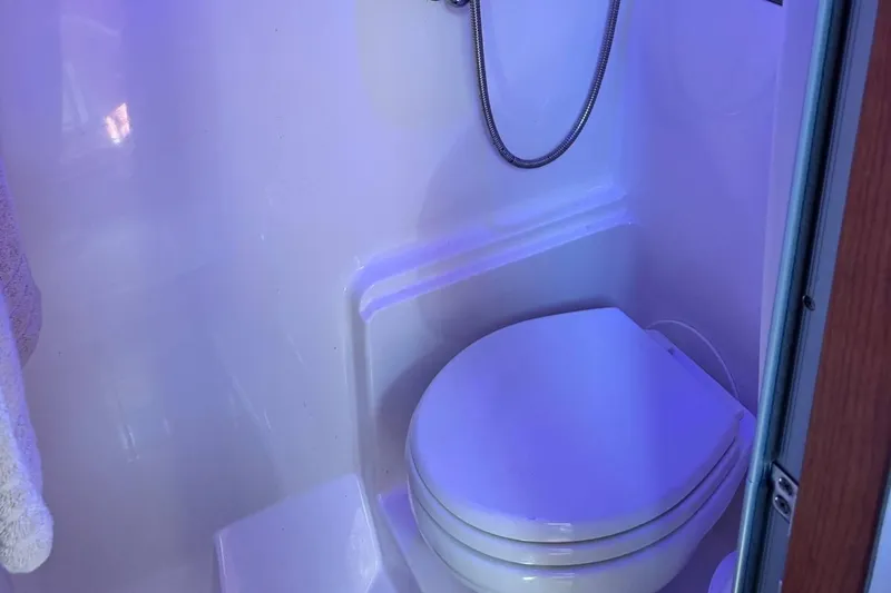 Out With The Buoys II Yacht Photos Pics Compact bathroom in 2009 Regal Commodore 4060 yacht with toilet and shower.