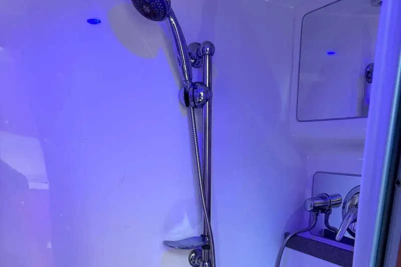 Out With The Buoys II Yacht Photos Pics Shower area in 2009 Regal Commodore 4060 boat with modern fixtures and blue lighting.