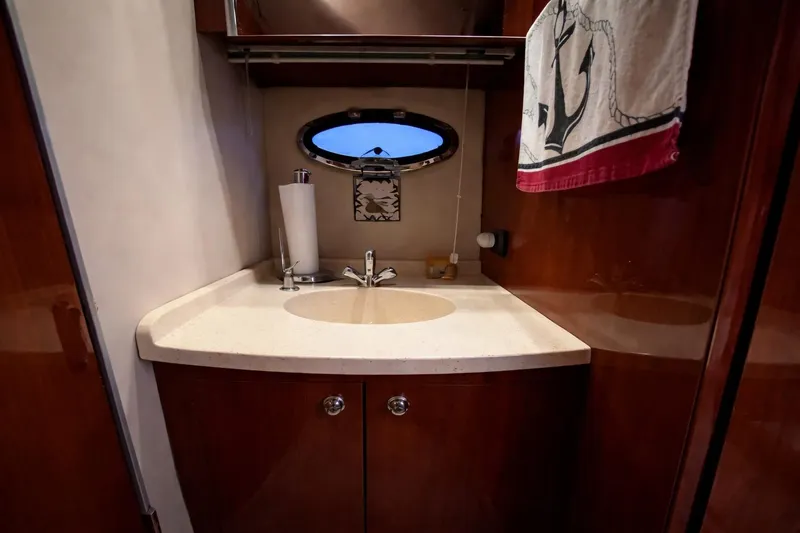 Out With The Buoys II Yacht Photos Pics Luxurious bathroom in 2009 Regal Commodore 4060 yacht with elegant wood finish.