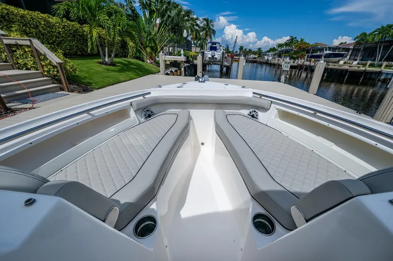  Yacht Photos Pics 2022 Pursuit DC 246 Dual Console boat interior with luxurious seating and waterfront view.