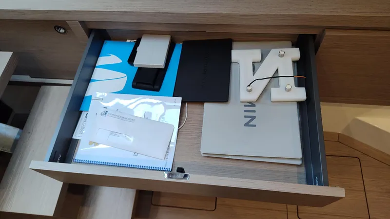 Nauti Mate Yacht Photos Pics Open drawer on Pardo Yachts P43, 2023 model, with documents and electronic devices.