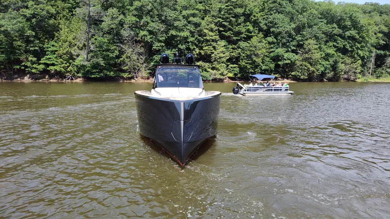 Nauti Mate Yacht Photos Pics 2023 Pardo Yachts P43 cruising on a lake with lush green forest backdrop.