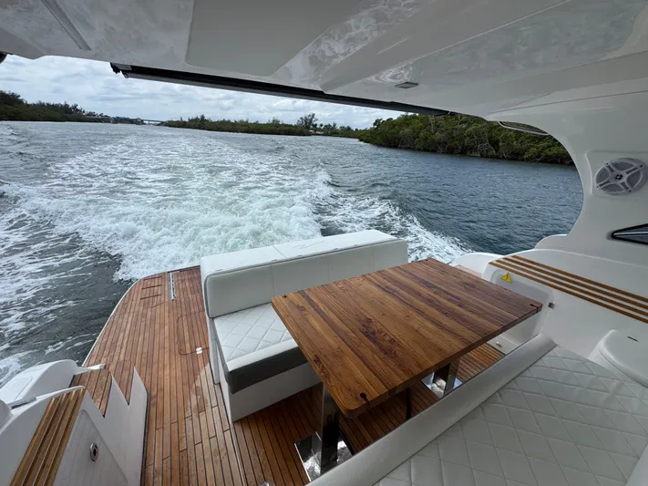  Yacht Photos Pics Luxurious 2025 Real 40 HT yacht interior with wooden table, cruising on a scenic waterway.