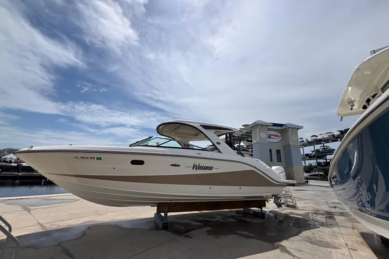  Yacht Photos Pics 2018 Sea Ray SLX 310 Outboard boat on display at a marina under a cloudy sky.