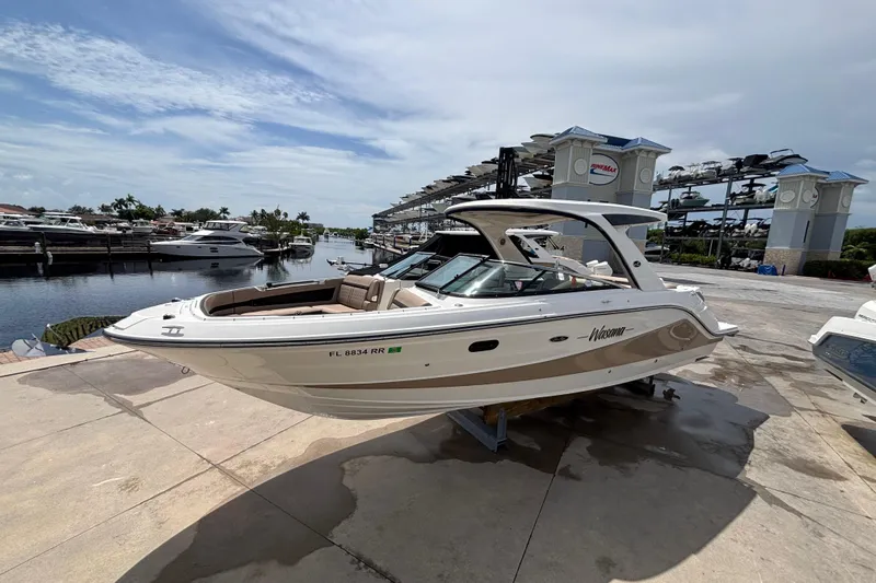  Yacht Photos Pics 2018 Sea Ray SLX 310 Outboard boat docked at a marina under a clear sky.
