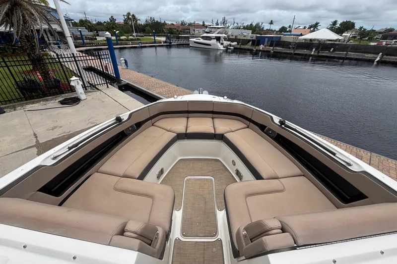 Yacht Photos Pics 2018 Sea Ray SLX 310 Outboard boat with spacious seating at a marina dock.