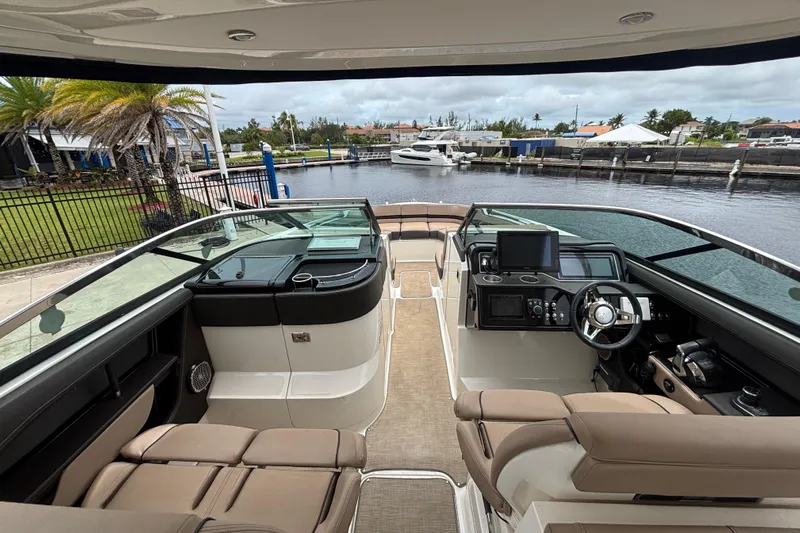  Yacht Photos Pics 2018 Sea Ray SLX 310 Outboard interior with helm, seating, and waterfront view.