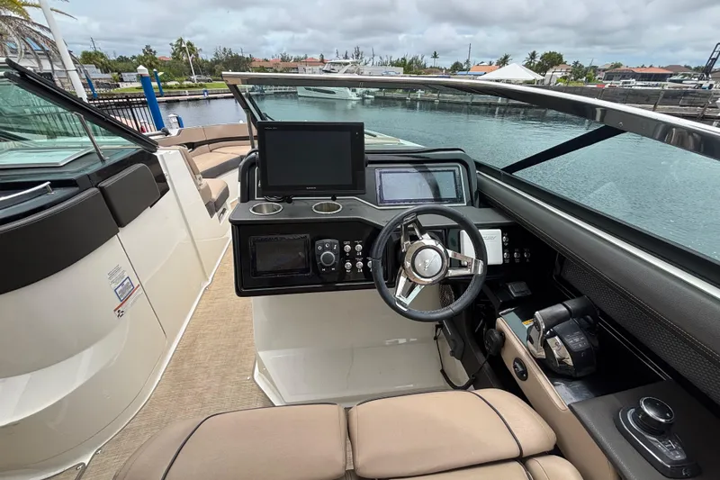  Yacht Photos Pics 2018 Sea Ray SLX 310 Outboard helm with modern controls and waterfront view.