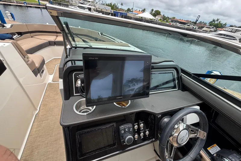  Yacht Photos Pics 2018 Sea Ray SLX 310 Outboard helm with Garmin GPS, steering wheel, and cup holder.