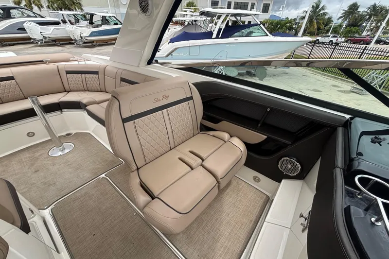  Yacht Photos Pics Luxurious interior of 2018 Sea Ray SLX 310 Outboard with beige seating and modern design.