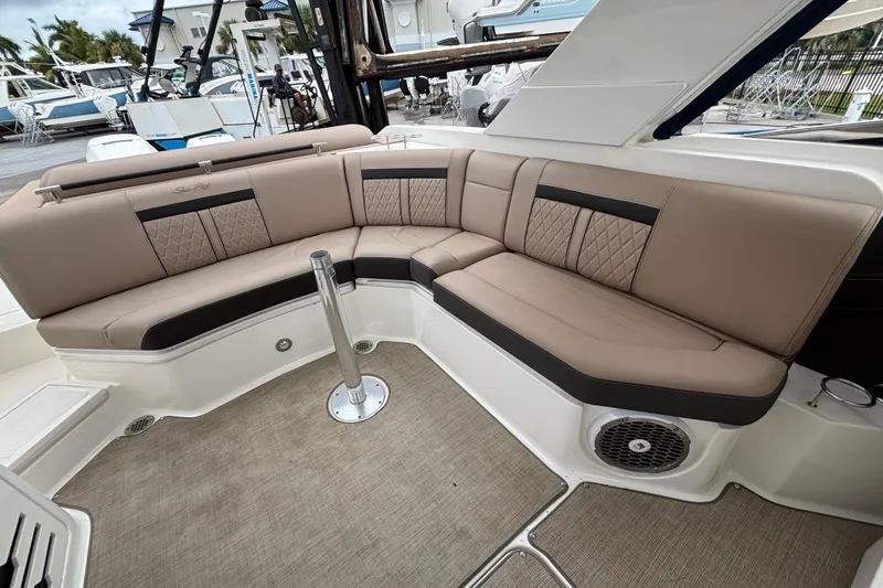  Yacht Photos Pics Luxurious seating on 2018 Sea Ray SLX 310 Outboard boat, featuring elegant upholstery and spacious design.