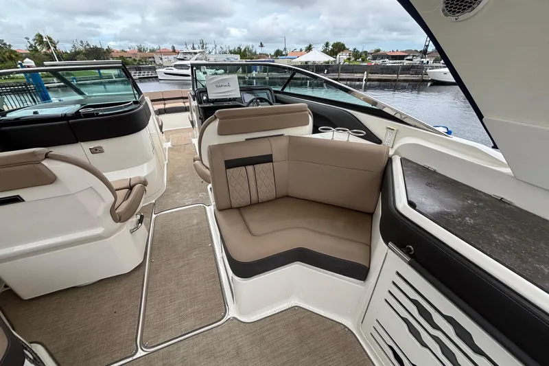  Yacht Photos Pics 2018 Sea Ray SLX 310 Outboard interior with beige seating and modern dashboard.