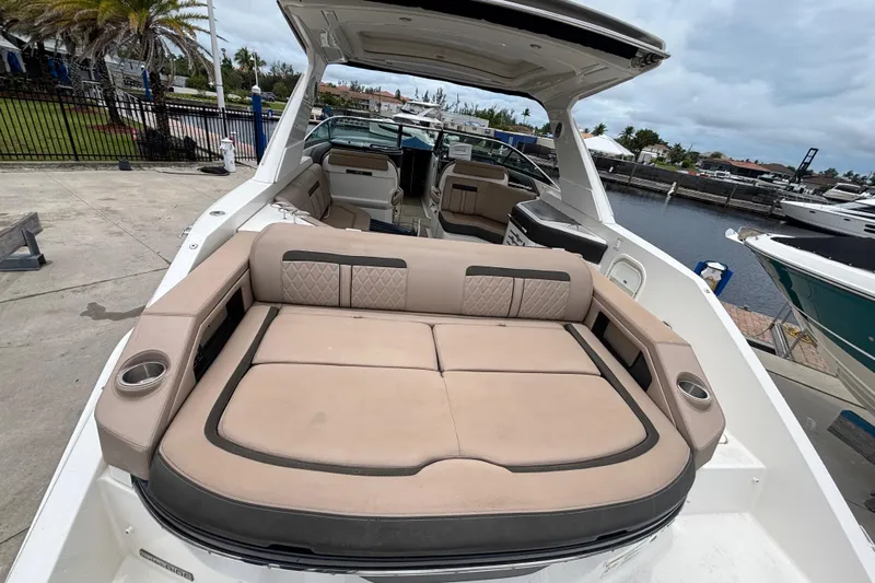 Yacht Photos Pics 2018 Sea Ray SLX 310 Outboard boat with spacious seating and luxurious interior at a marina.