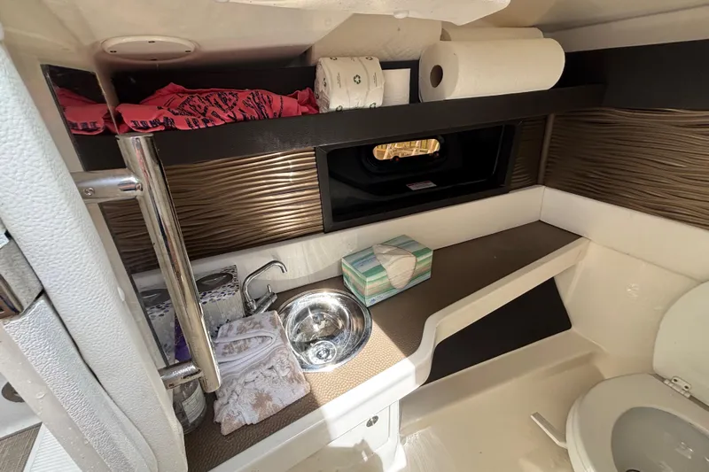  Yacht Photos Pics 2018 Sea Ray SLX 310 Outboard bathroom with sink, towels, and storage shelves.