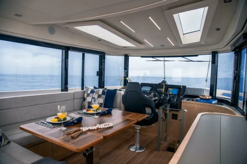  Yacht Photos Pics Luxurious interior of 2025 OKEAN 52 yacht with ocean view and elegant dining setup.