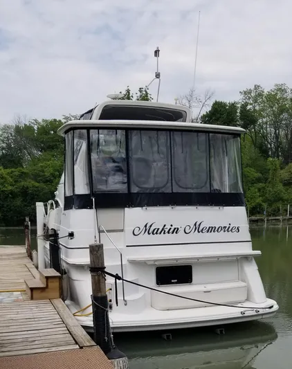 Makin Memories Yacht Photos Pics 2003 Carver 396 yacht named "Makin Memories" docked by a serene, wooded shoreline.