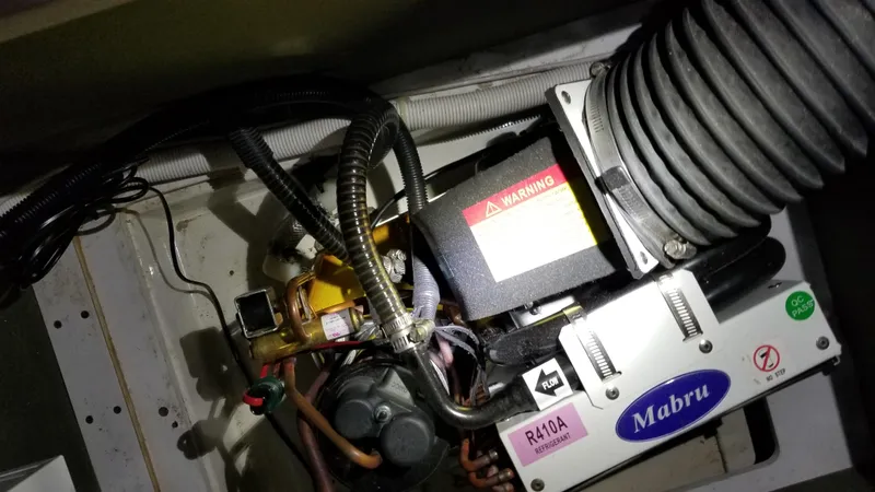 Makin Memories Yacht Photos Pics Engine compartment of a 2003 Carver 396 with Mabru air conditioning unit and R410A refrigerant.