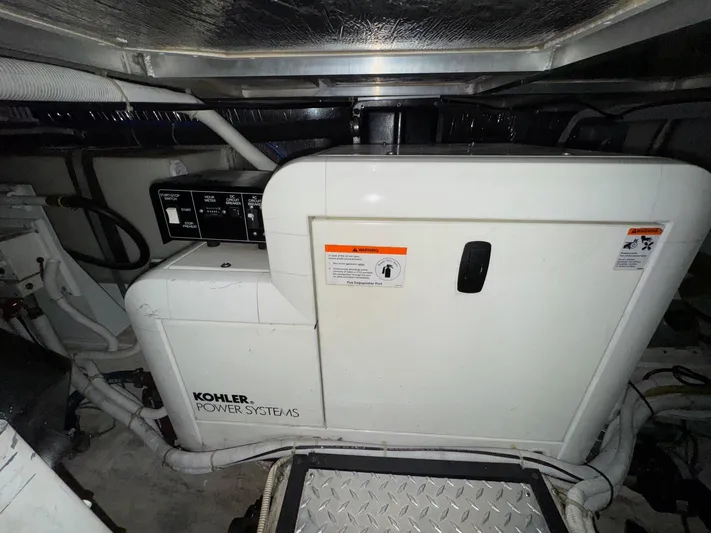 Makin Memories Yacht Photos Pics Kohler power system in 2003 Carver 396 engine room, featuring control panel and wiring.