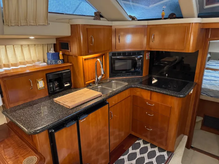 Makin Memories Yacht Photos Pics Luxurious 2003 Carver 396 yacht kitchen with modern appliances and elegant wood cabinetry.