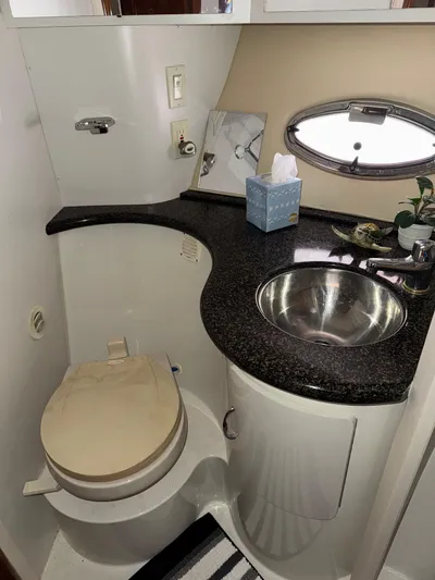 Makin Memories Yacht Photos Pics 2003 Carver 396 yacht bathroom with sink, toilet, and porthole window.
