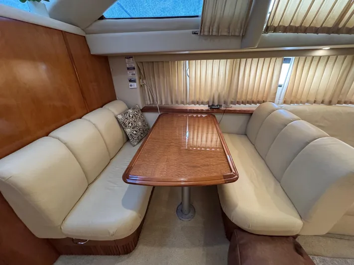 Makin Memories Yacht Photos Pics Interior of 2003 Carver 396 yacht with beige seating and wooden table.