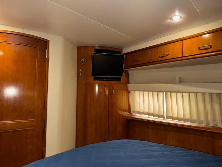 Makin Memories Yacht Photos Pics Interior of 2003 Carver 396 yacht with wood cabinetry and mounted TV.