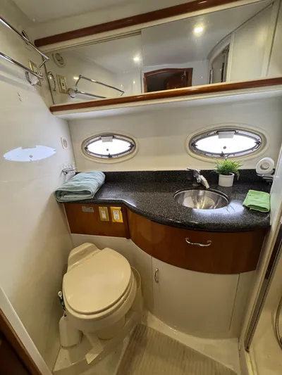 Makin Memories Yacht Photos Pics 2003 Carver 396 yacht bathroom with sink, toilet, and oval windows.
